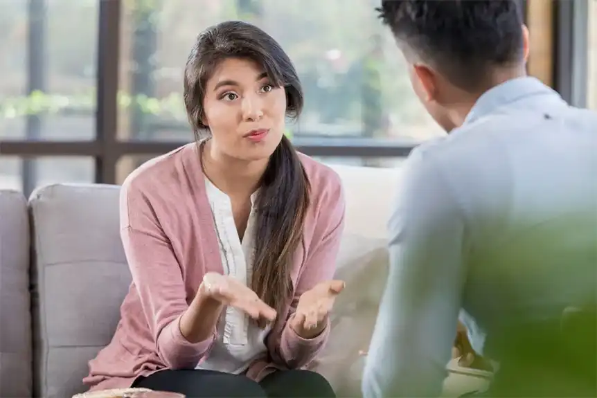 A woman speak to a man using person-first language.